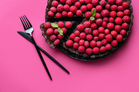 Board with tasty raspberry pie and mint on color background