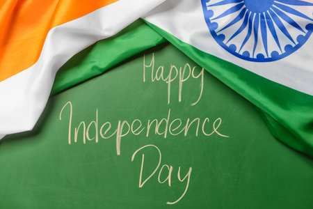 Indian flag and text HAPPY INDEPENDENCE DAY on color backgroundの写真素材