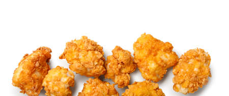 Crunchy fried popcorn chicken on white backgroundの写真素材