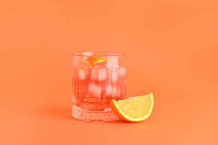 Glass of tasty Negroni cocktail on color backgroundの写真素材