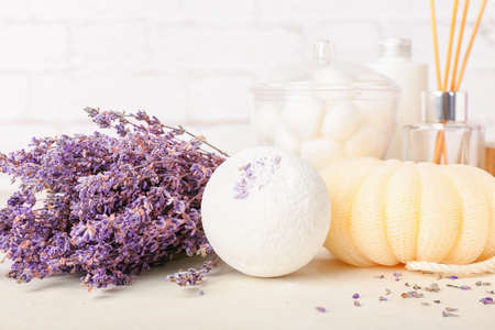 Set of bath supplies and lavender flowers on light backgroundの写真素材