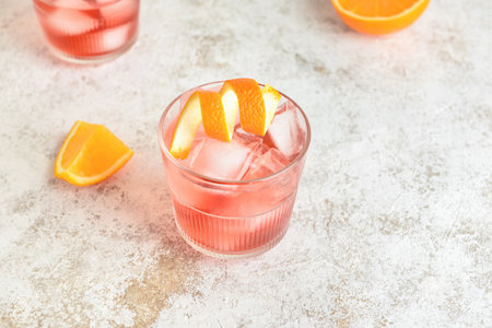 Glass of tasty Negroni cocktail on light background
