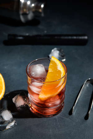 Glass of tasty Negroni cocktail on dark backgroundの写真素材