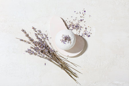 Composition with bath bomb and lavender flowers on light backgroundの写真素材