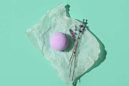 Bath bomb and lavender flowers on color backgroundの写真素材