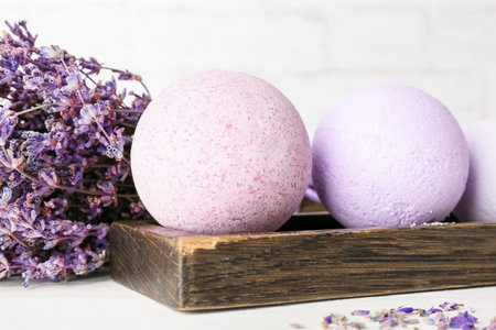 Tray with bath bombs and lavender flowers on light background, closeupの写真素材