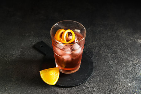 Glass of tasty Negroni cocktail on dark background