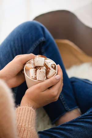 Woman holding cup of delicious cacao with marshmallow, closeupの写真素材