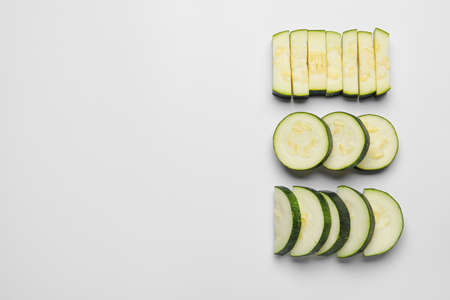 Slices of fresh zucchini squash on white backgroundの写真素材
