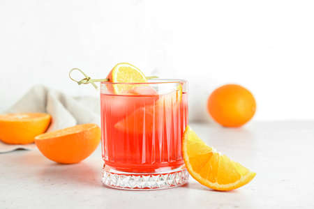 Glass of tasty Negroni cocktail on light background
