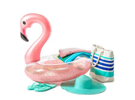 Inflatable ring and beach accessories on white background