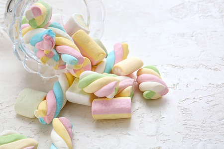 Glass bowl with tasty marshmallows on white background, closeup