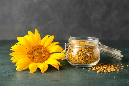 Jar of bee pollen on dark backgroundの写真素材