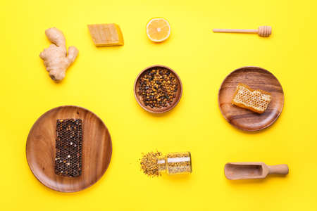 Different bee products with lemon and ginger on color backgroundの写真素材