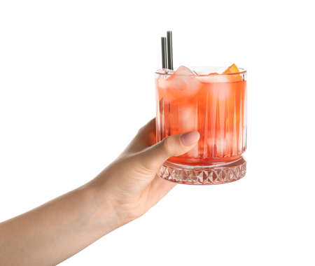Woman holding glass of negroni cocktail on white backgroundの写真素材