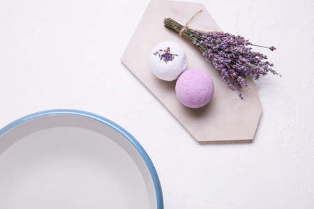 Bath bombs, lavender flowers and bowl with water on light background, closeupの写真素材