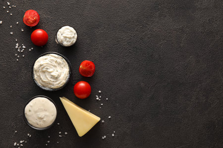 Composition with tasty Caesar sauce on black backgroundの写真素材