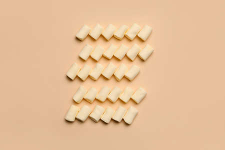 Delicious marshmallows on color background
