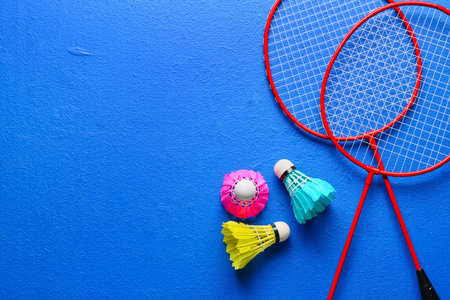 Badminton rackets and shuttlecocks on color backgroundの写真素材