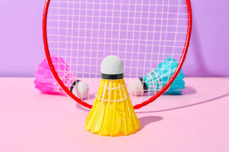 Badminton racket and shuttlecocks on color backgroundの写真素材