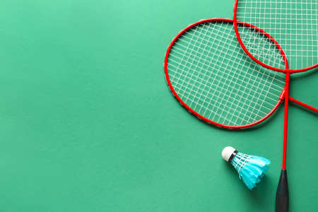 Badminton rackets and shuttlecock on color backgroundの写真素材
