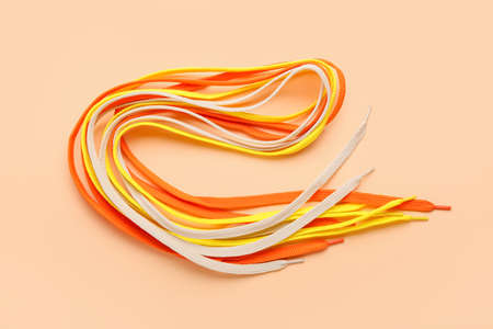 Many shoe laces on color background