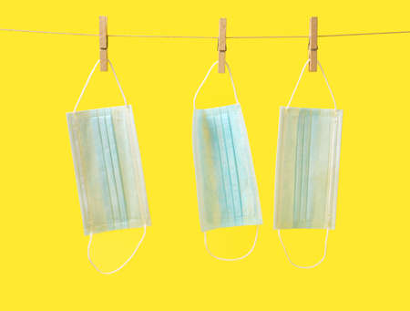 Closes line with medical masks on color backgroundの写真素材