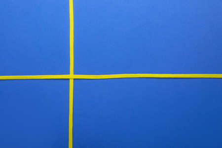 Yellow shoe laces on blue background, closeupの写真素材