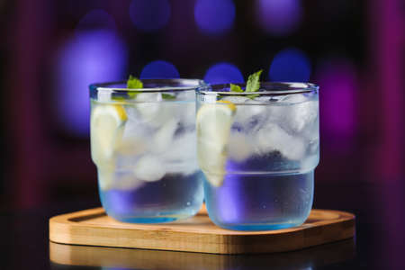 Glasses of cold gin tonic on table in barの写真素材