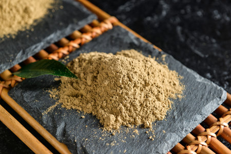 Bamboo mat with hojicha powder on black background, closeupの写真素材
