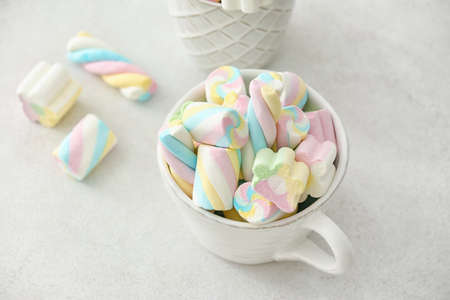 Cup with sweet marshmallows on white backgroundの写真素材
