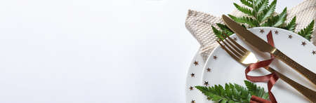 Elegant table setting with fern leaves on light background with space for textの写真素材