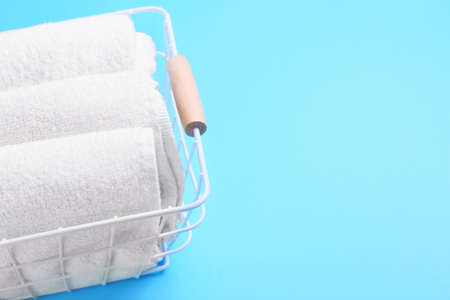 Basket with clean towels on blue background, closeupの写真素材