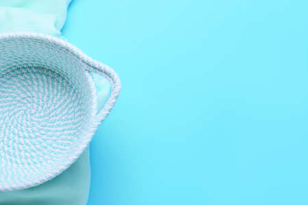 Empty basket and cloth on blue background, closeupの写真素材