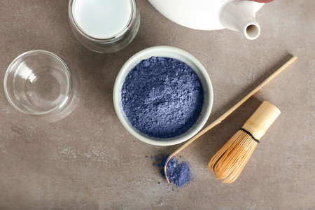 Bowl of powdered blue matcha tea, chasen and chashaku on grunge backgroundの写真素材