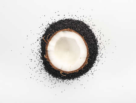 Ripe coconut half with activated carbon on white backgroundの写真素材