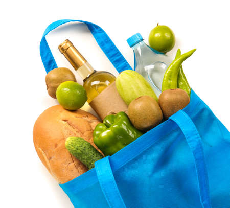 Eco bag with scattered products, bottle of wine and water on white background