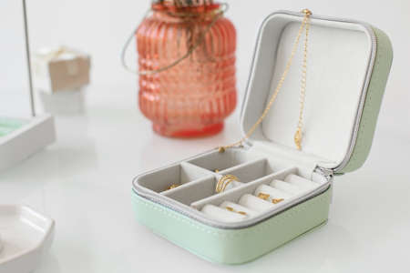 Jewelry box with trendy accessories on tableの写真素材