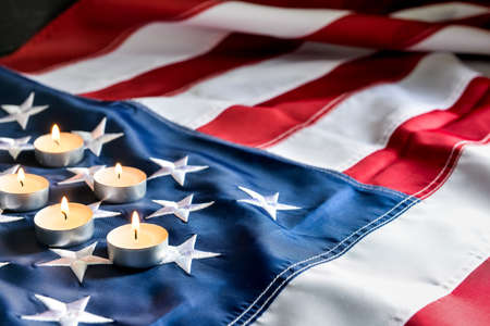 Burning candles on USA flag. National Day of Prayer and Remembrance for the Victims of the Terrorist...