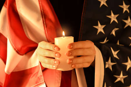 Woman with burning candle. National Day of Prayer and Remembrance for the Victims of the Terrorist Attacksの写真素材