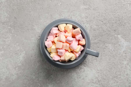 Cup with tasty marshmallows on gray backgroundの写真素材