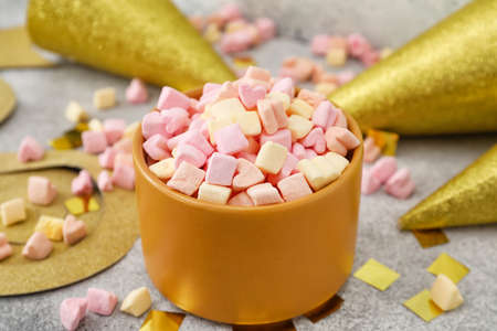 Bowl with tasty marshmallows on gray background, closeup