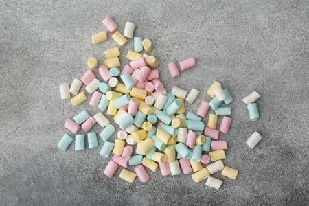 Tasty colorful marshmallows on gray background