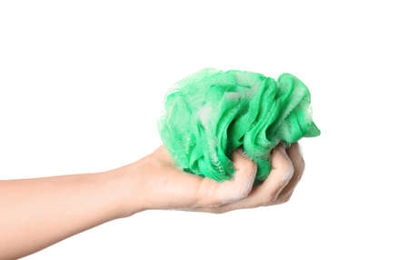 Female hand with green bath sponge on white background, closeupの写真素材