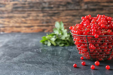 Basket with fresh red currants on table, closeupの写真素材