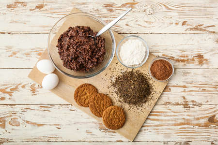 Board with tasty hojicha cookies and ingredients on white wooden backgroundの写真素材