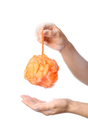 Woman holding orange bath sponge with foam on white background, closeupの写真素材
