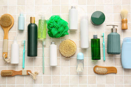 Bath accessories and cosmetics on light tiles, closeup