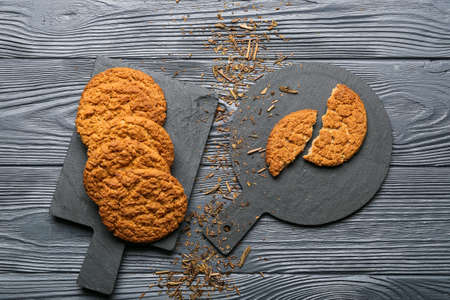 Boards with tasty hojicha cookies on black wooden backgroundの写真素材