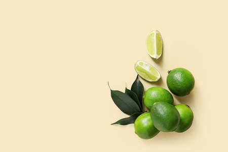 Tasty limes on color background